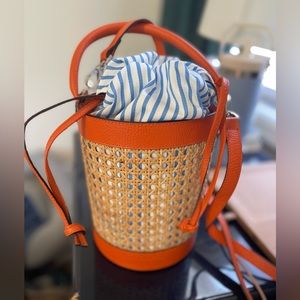 Rue Des Fleurs Monaco orange leather and rattan/cane bucket bag blue strip